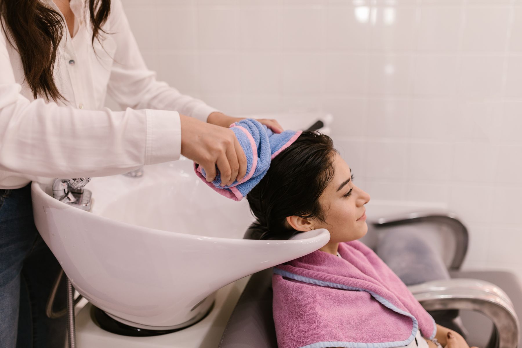 Client having her hair washed at the basin